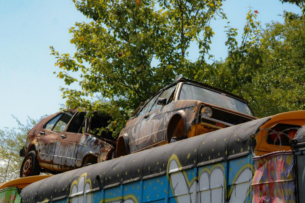 Two old, rusty cars.