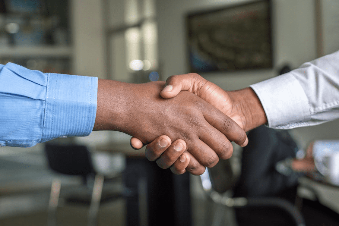 two individuals shaking hands